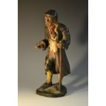 A 19th century Italian polychrome-painted terracotta figure, of an elderly vagabond, 32cm high, c.