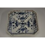 A Chinese porcelain canted square dish, decorated in underglaze blue with stylized flowers,