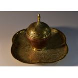 A 19th century brass and copper desk inkwell, in the Indian taste,