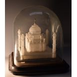 A 19th century Indian alabaster model, of the Taj Mahal, Agra, glass dome with ebonised base,