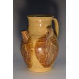 A Chinese baluster earthenware ewer, moulded in relief with figures and a fish,