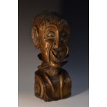 A 19th century oak figural corbel, comically carved with the face of a grotesque gentleman,