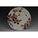 A Japanese circular porcelain charger, painted in tones of cobalt blue, iron red and gilt,
