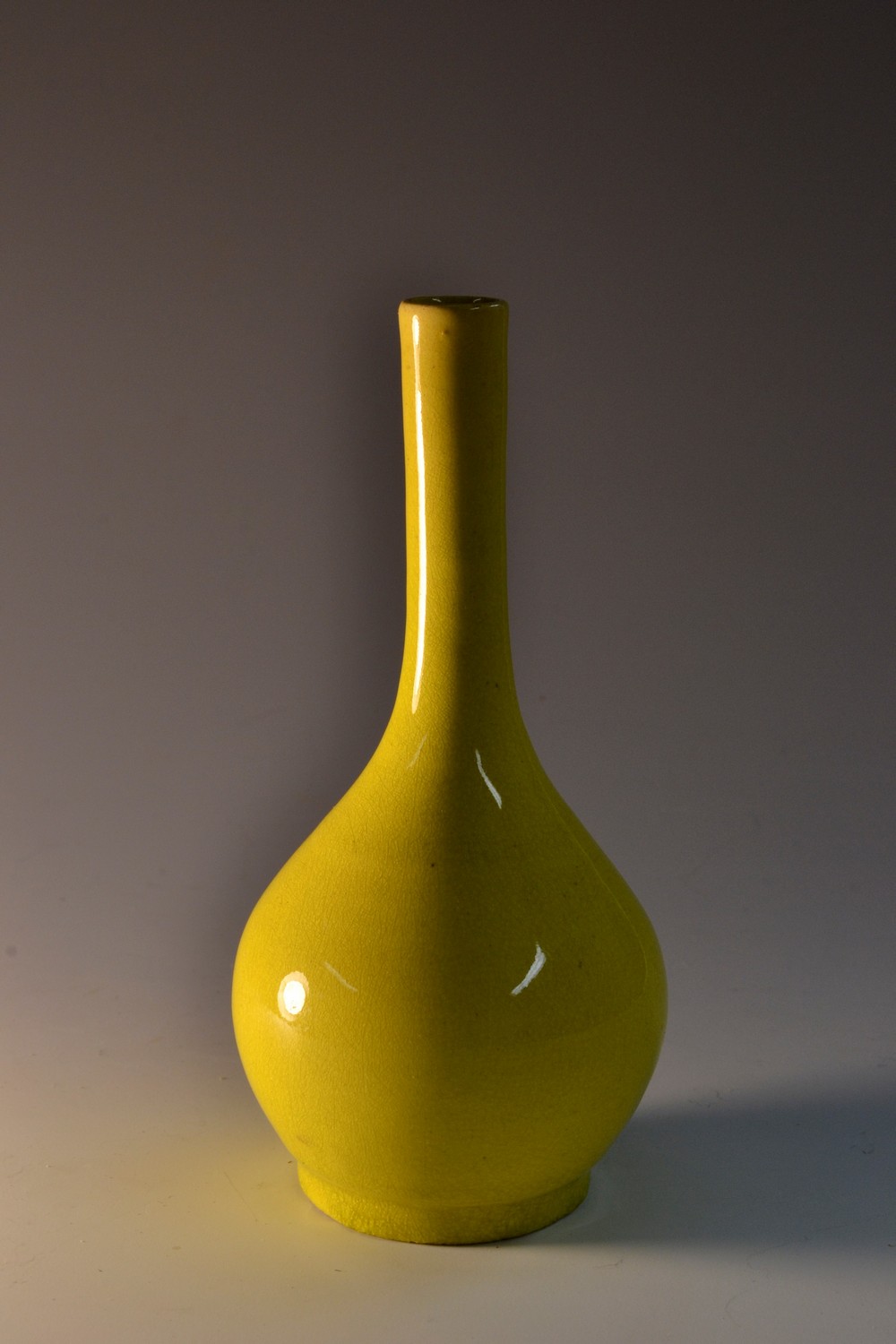A 19th century Chinese bottle vase, boldly glazed in vibrant yellow, circular foot, 12.