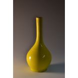 A 19th century Chinese bottle vase, boldly glazed in vibrant yellow, circular foot, 12.