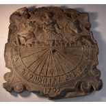 A lead sundial, in relief with Apollo in his chariot, heralding the dawn, above a demi-lune scale,