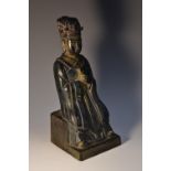A Chinese gilt and polychrome painted bronze figure, of an elder, seated holding a sceptre,