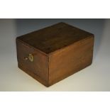 A 19th century mahogany cash box, the flush top with three coin apertures, above a drawer,