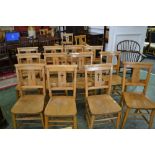 Twenty beech chapel chairs, curved top rail, crucifix pierced splat, hymnal shelf to back,