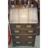 A small brass bound oak campaign bureau, fall front enclosing pigeon holes and drawer,