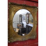 A large gesso framed oval wall mirror