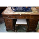 A Regency mahogany bow front desk and a stool.