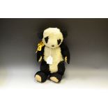 An early 20th century jointed panda teddy bear