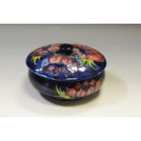 A Moorcroft Anemone pattern circular trinket dish and cover, blue ground,