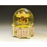 A large musical carousel snow globe,