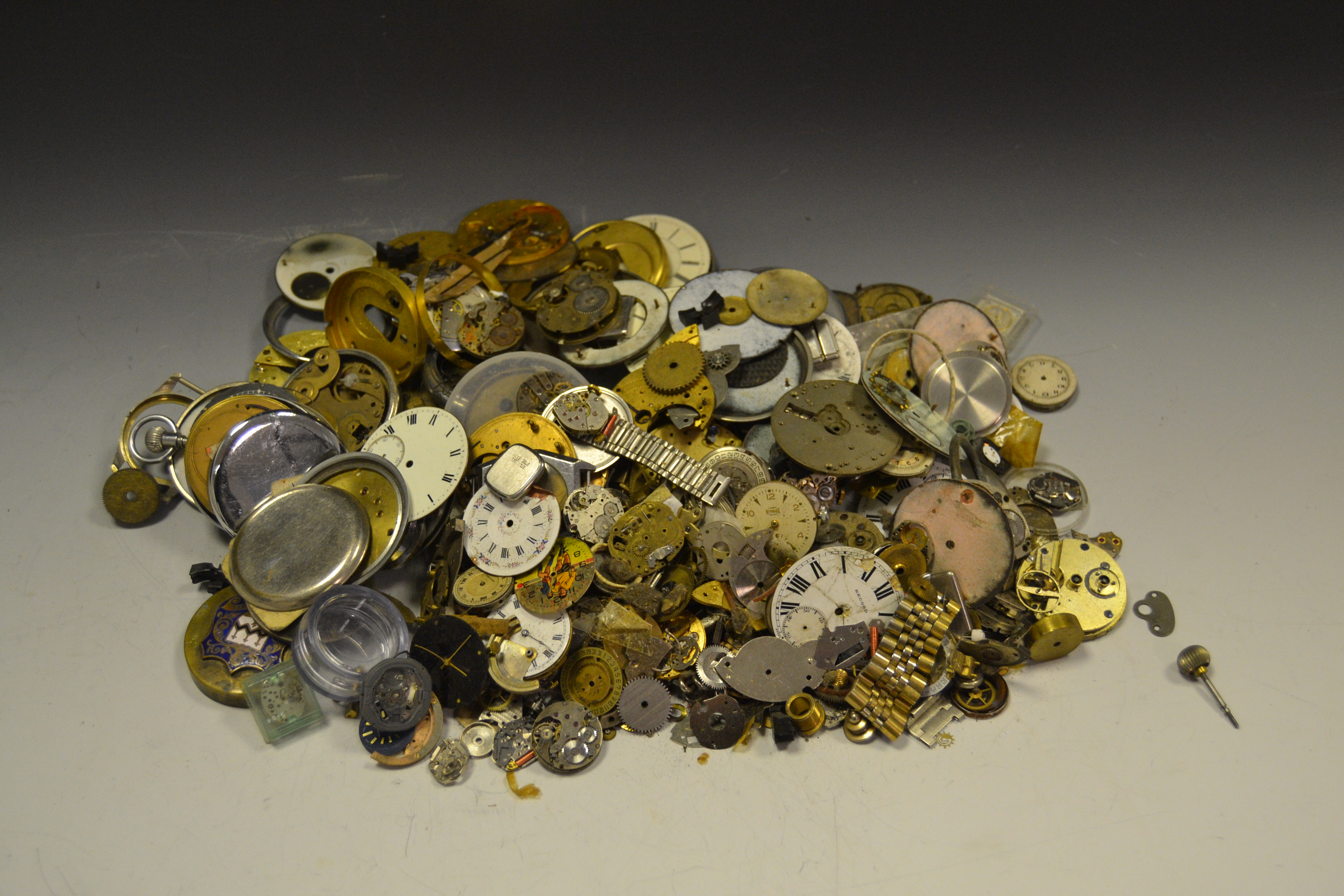 A quantity of Watchmakers spares including cases, movements ,