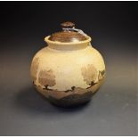 An Art Pottery vase and cover, village trees landscape,