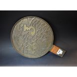 A large Japanese bronze hand mirror, verso cast in relief with cranes, turtle and script,