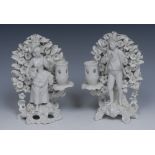 A pair of 19th century hard paste smokey glazed blanc de chine figural candlestick,