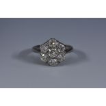 A seven stone diamond flower head cluster ring,