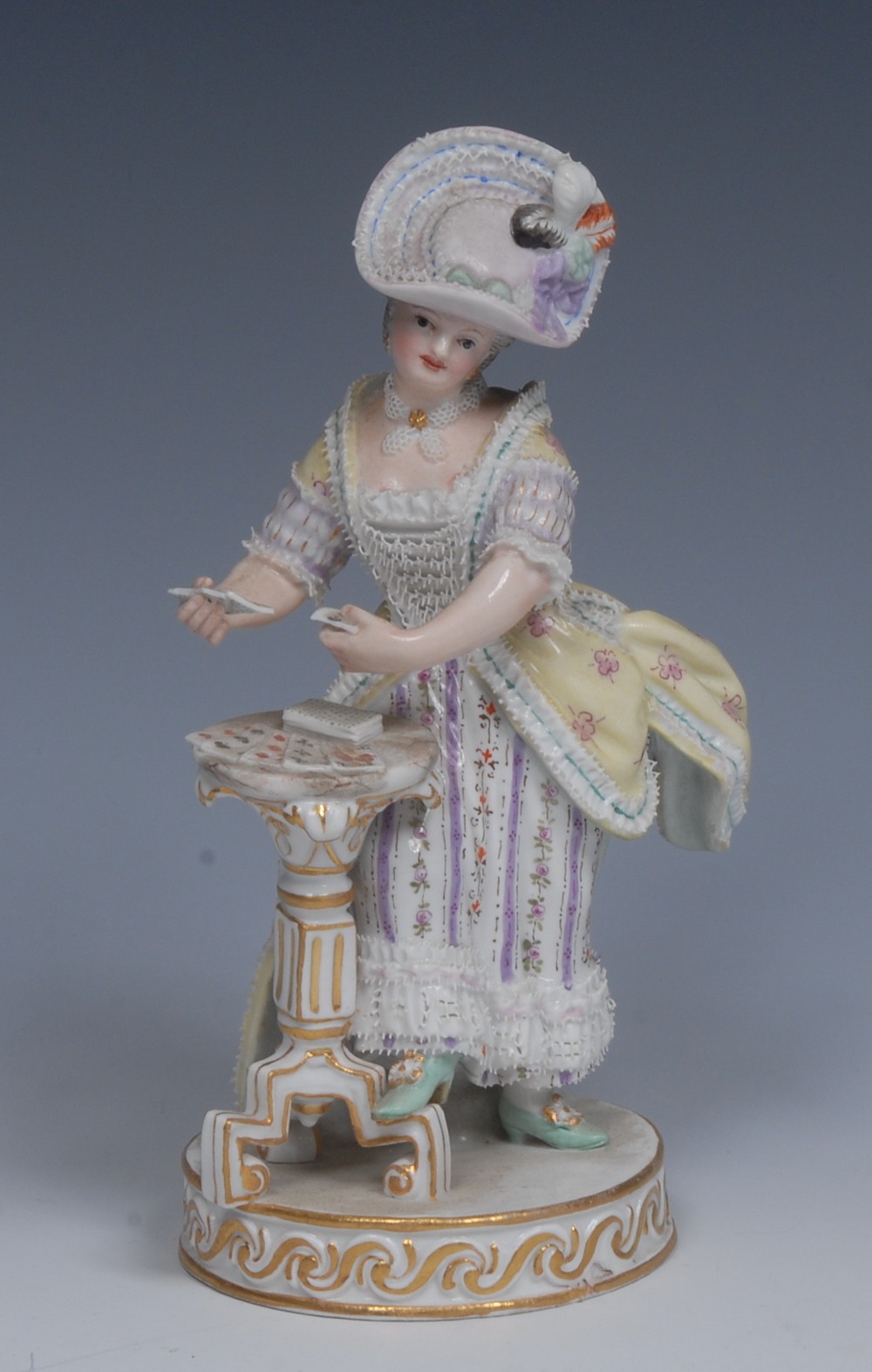 A 19th century Meissen figure, The Female Card Player, modelled after Michel Victor Acier,