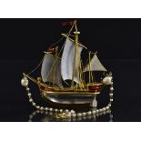 A fine enamel rock crystal and pearl three masted ship pendant, rock crystal hull,