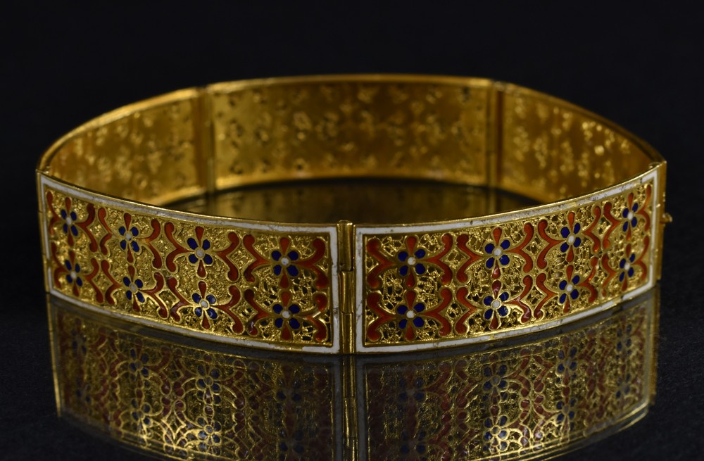 A Middle Eastern enamelled yellow metal panel bracelet,