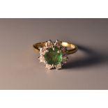A diamond and emerald floral cluster ring, central round emerald approx 0.