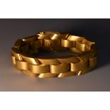 A Modernist design articulated offset three row arching link tank track bracelet,