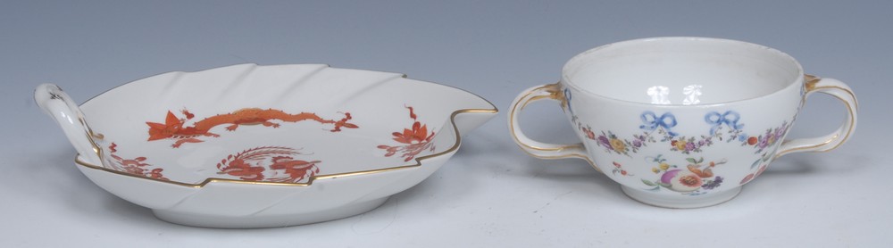 A Meissen leaf shaped dish, painted with a red dragons, gilt line rim, rustic loop handle,