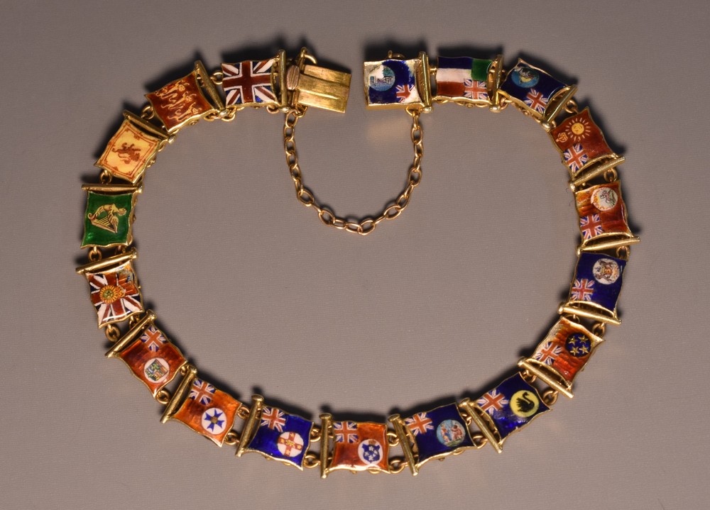 A silver gilt and enamelled panel bracelet, each enamelled with a different countries flag,