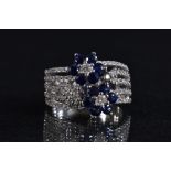 A Damas diamond and sapphire floral cluster ring,