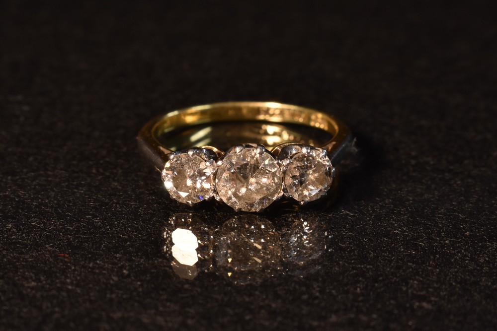 A graduated diamond trilogy ring, round brilliant cut, total estimated diamond weight approx 1.