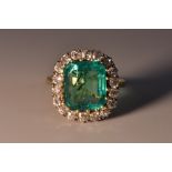 A Columbian emerald and diamond cluster ring, central rectangular emerald cut emerald approx 5.