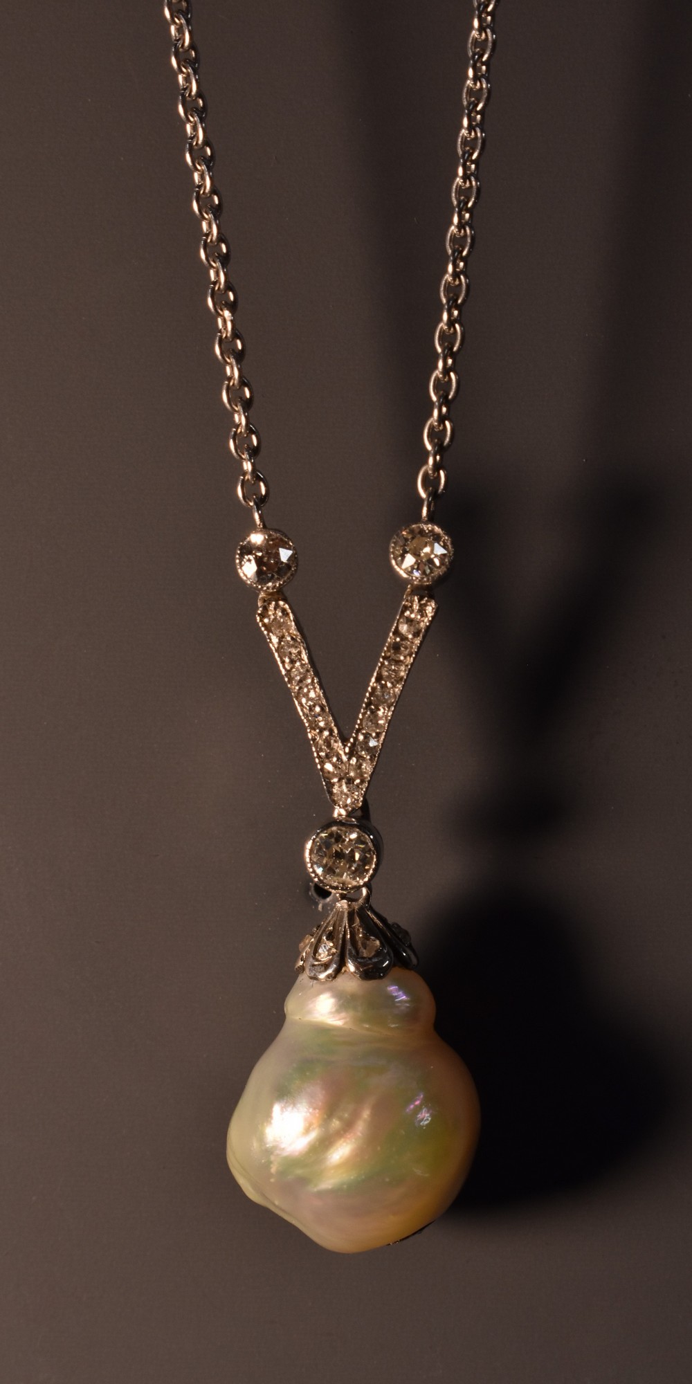 A natural salt water pearl and diamond pendant necklace,