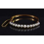 A diamond and cultured pearl hinge bangle,