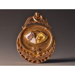 A 9ct gold enamelled football medal, awarded to J Brown Secy,