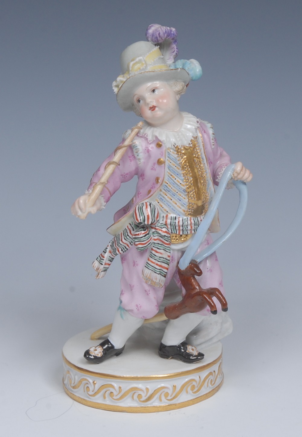 A Meissen figure, of a boy on a hobby horse, after the model by Christian Gottfried Juechtzer,