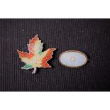 A sterling silver and enamel leaf brooch;