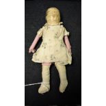 A late 18th century painted wooden and fabric doll, single piece solid head and body,
