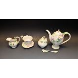 A Franz porcelain sweetpea pot, sucrier, creamer, cup and saucer, teaspoon,