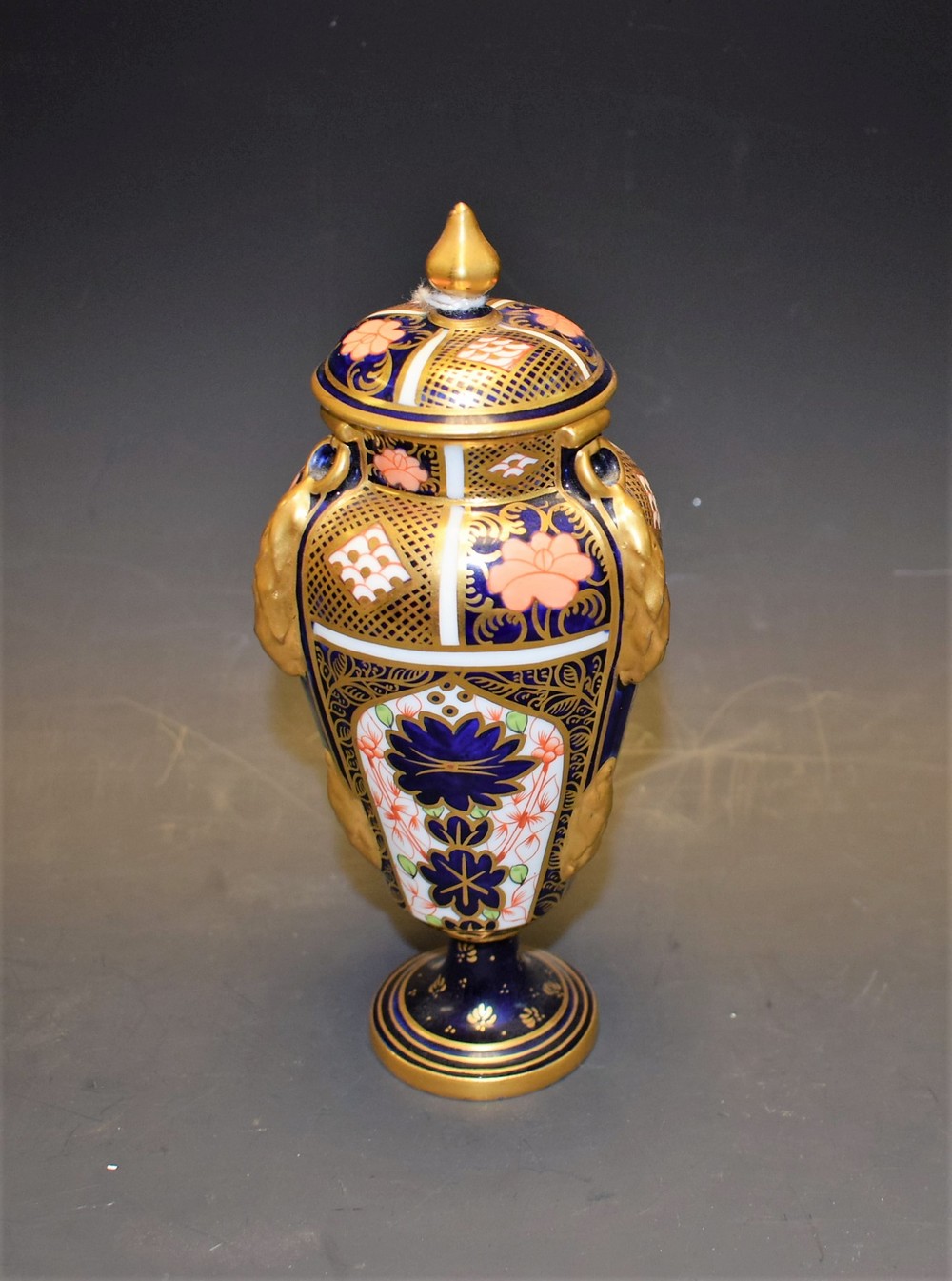 A Royal Crown Derby Imari palette tapering urnular vase and cover