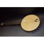 A banjo, mother of pearl inlaid frets, orante silver plated back, unmarked,