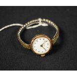 Rolex - a vintage Rolco 9ct lady's wrist watch, white enamel dial, Arabic numerals, blued hands,