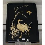 A Japanese carved bone inlaid panel, Crane amongst rushes, shaped rectangular frame,