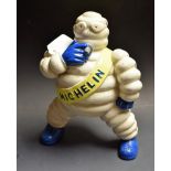 A cast metal figure of a Michelin compressor man.