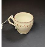 A Bristol porcelain barrel shaped coffee cup, the rim painted with a foliate garland, scroll handle,