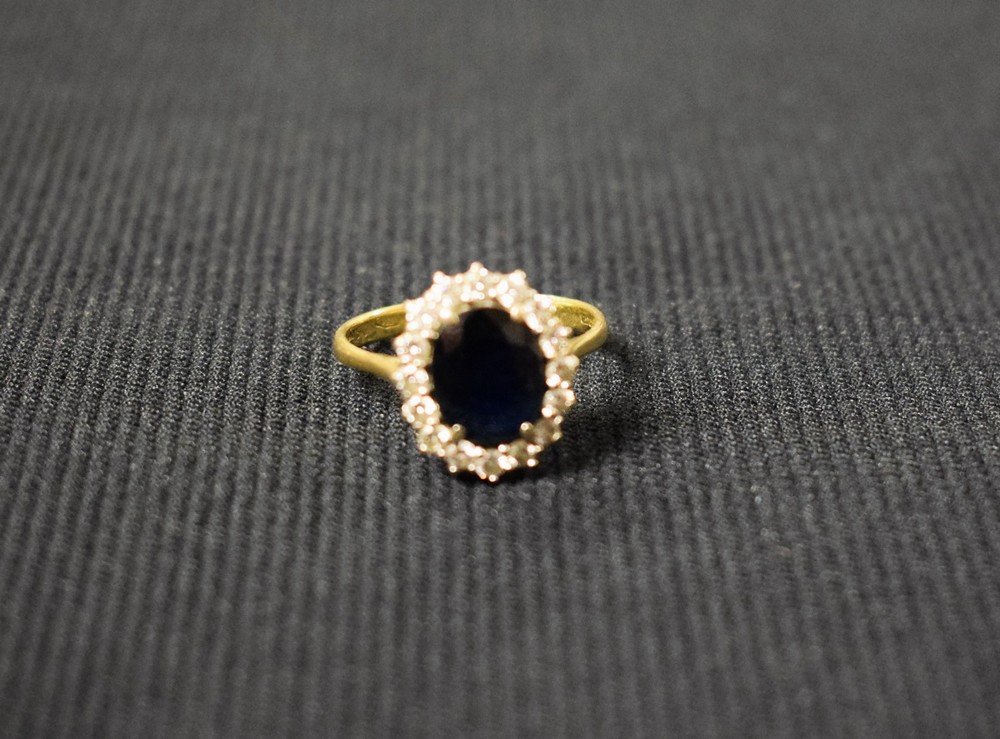 A diamond and dark blue spinel cluster ring, central oval dark blue spinel,