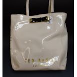 A Ted Baker cream vinyl shopper, Ted Baker logo, gold coloured bow, zipped internal pocket,