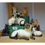 A Royal Doulton ceramic model of a Siamese cat; others, kittens, Beswick Siamese cat,